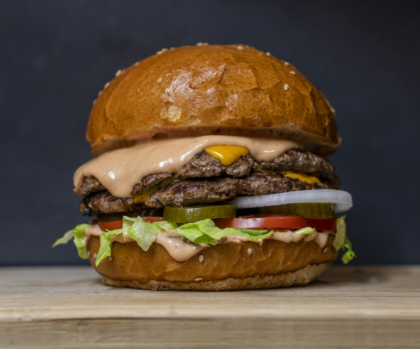 Illustrative gourmet cheeseburger with a toasted bun